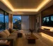 Warm LED lighting installed in a modern living room ceiling cove and TV console